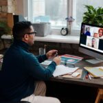 teacher-video-calling-with-his-students-using-a-computer